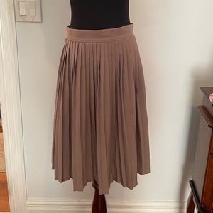 Size medium tan American Apparel pleated silky skirt, hits right above the knee